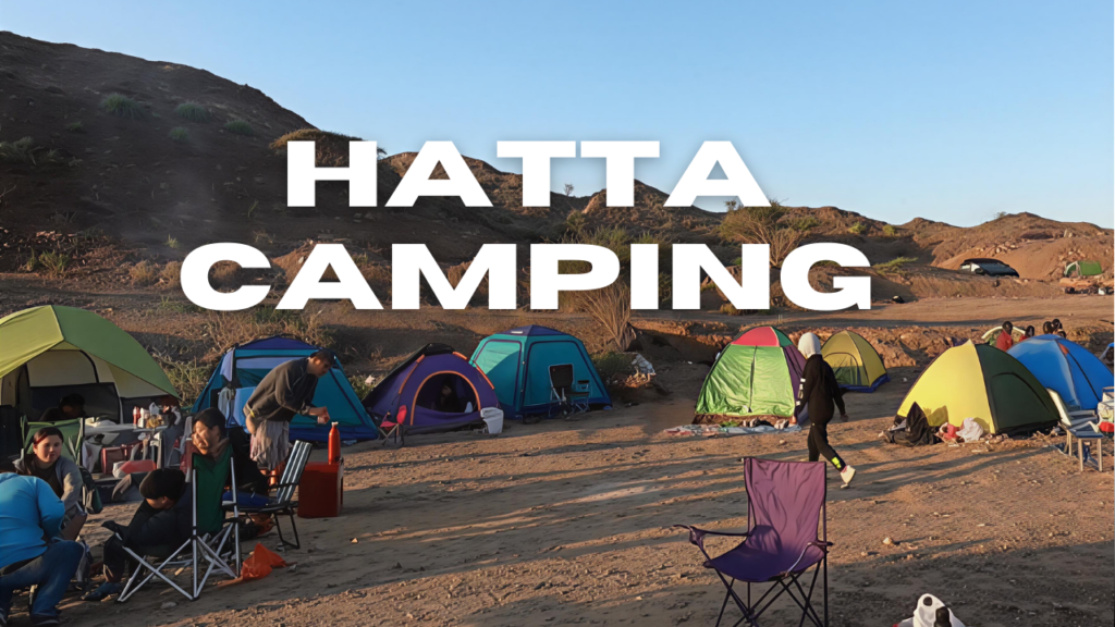 Visitors setting up tents for camping and stargazing in the Hatta mountain desert area.